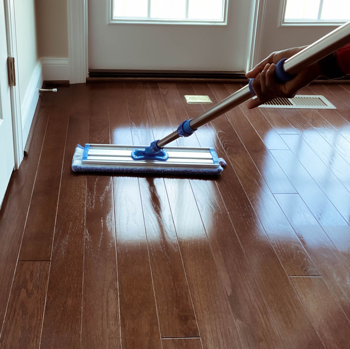 Professional hardwood floor mopping and maintenance for a spotless, shiny surface.