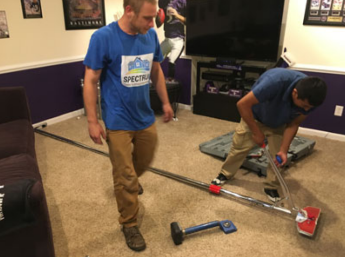 Spectrum Carpet Cleaning technicians performing professional carpet repair and stretching services.