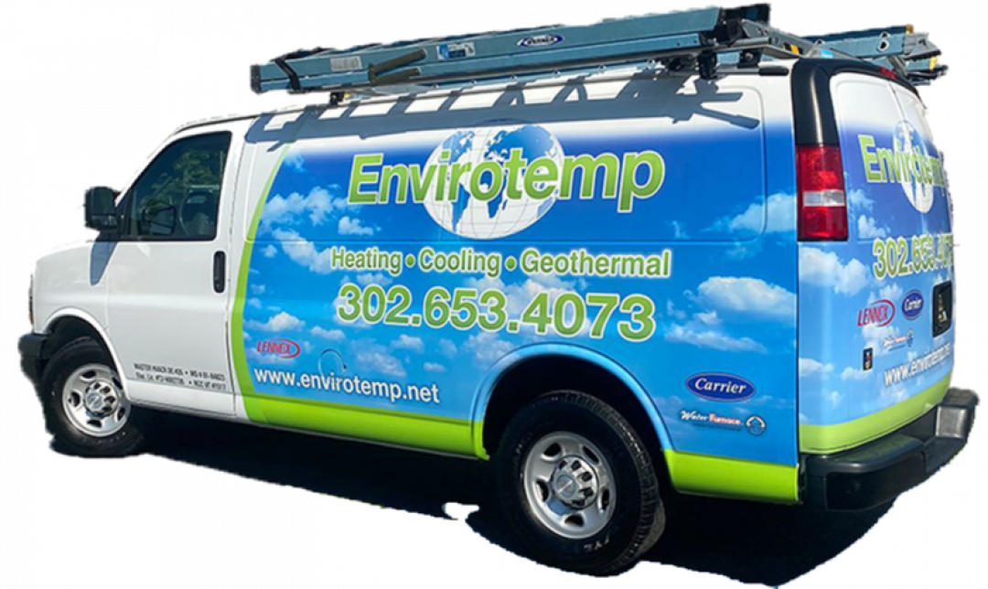White Enviroltemp service van with blue-green graphics and roof ladder, parked outdoors.