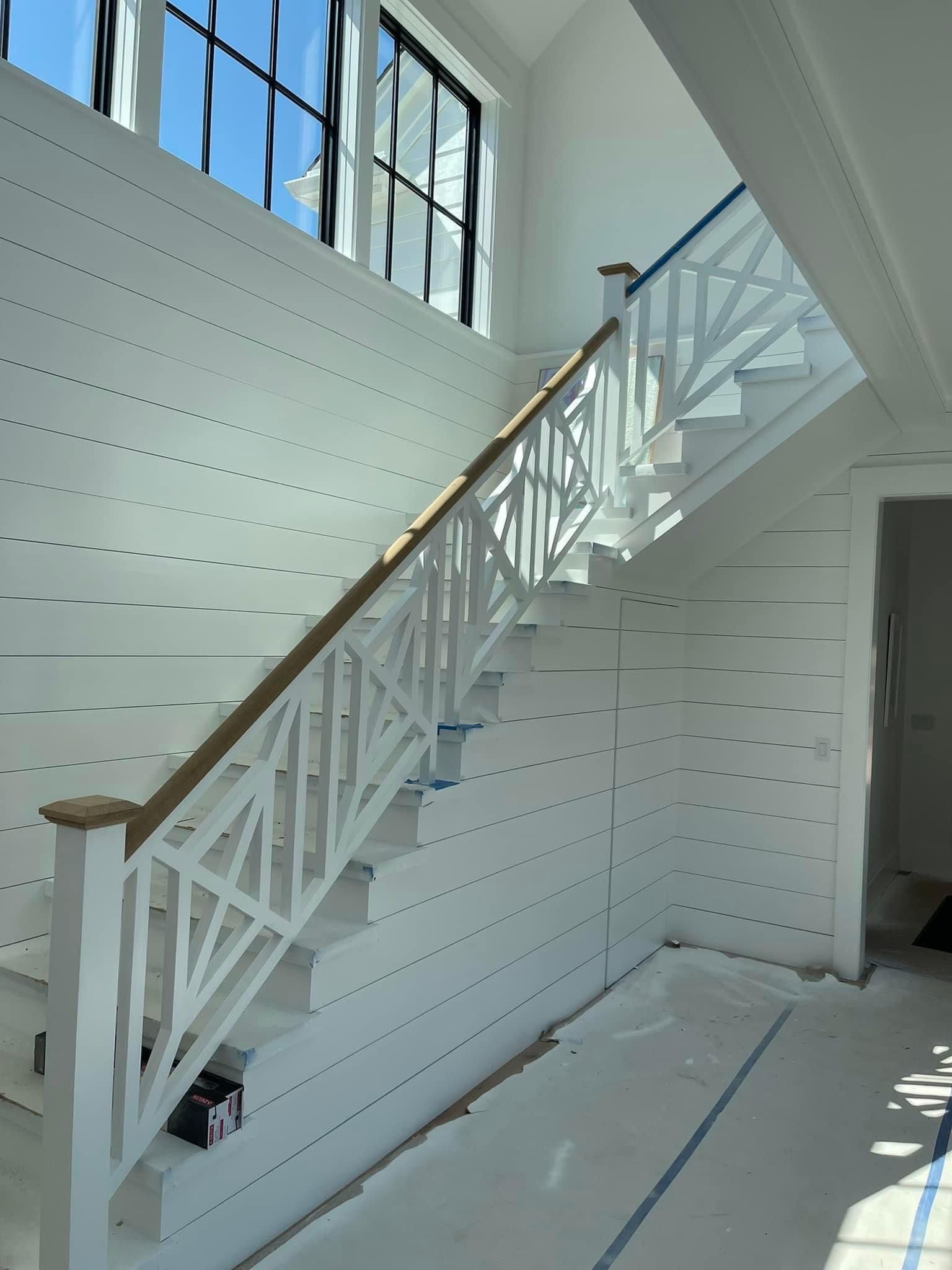 Indoor staircase featuring a custom-designed railing and modern architectural details by A&J Remodel and Construction in Houston
