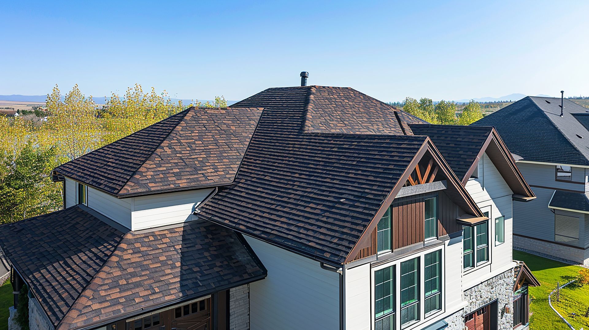 High-angle view of a completed roofing project on a large Houston home by A&J Remodel and Construction