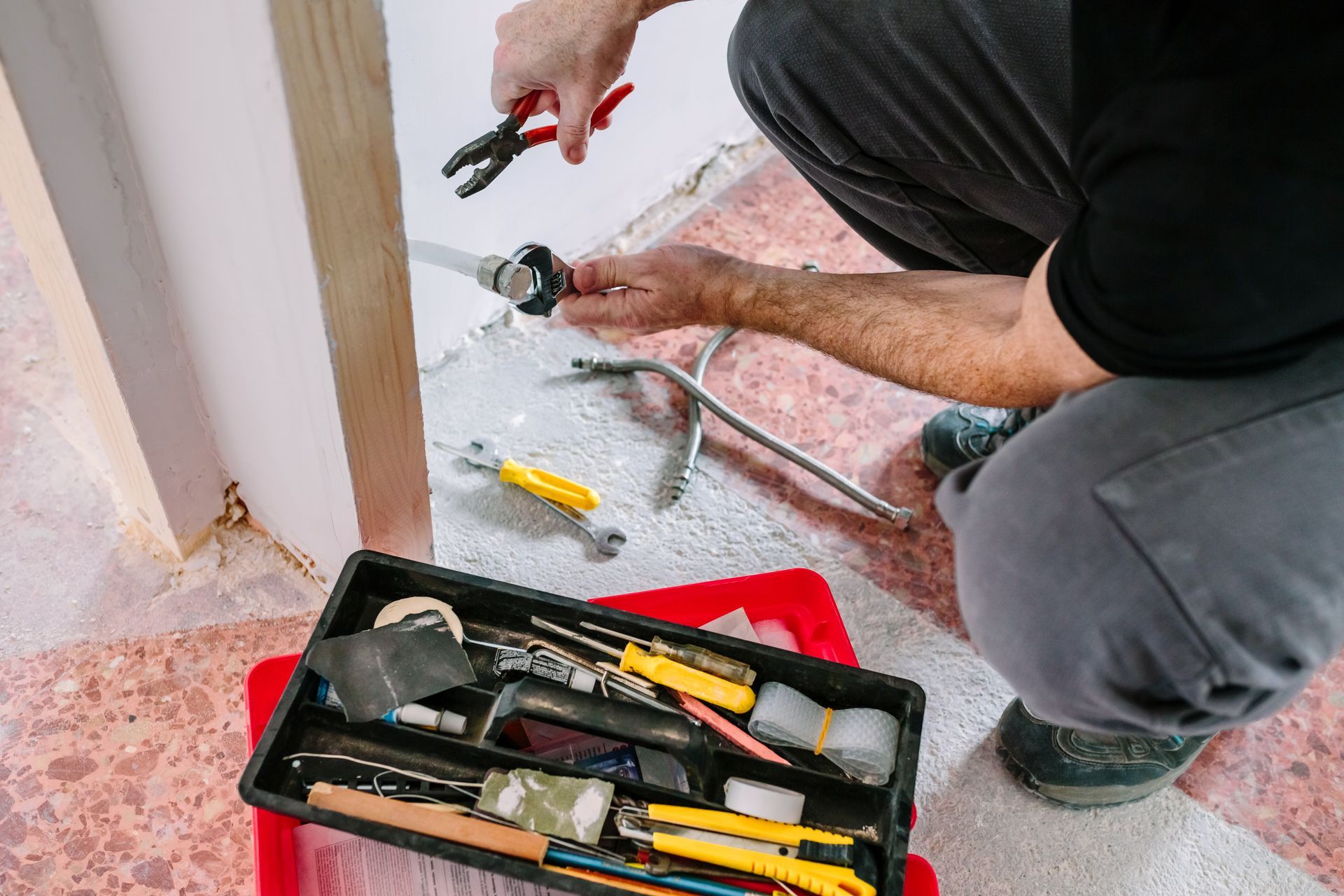 A&J Remodel and Construction handyman installing plumbing in a Houston home