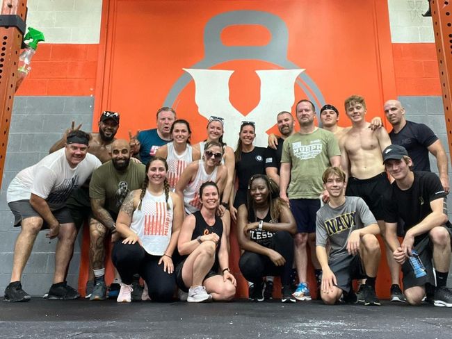 a group of people are doing exercises in a gym