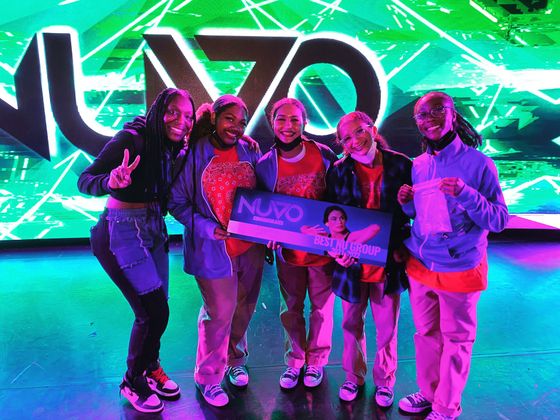 Five young dancers pose with a 