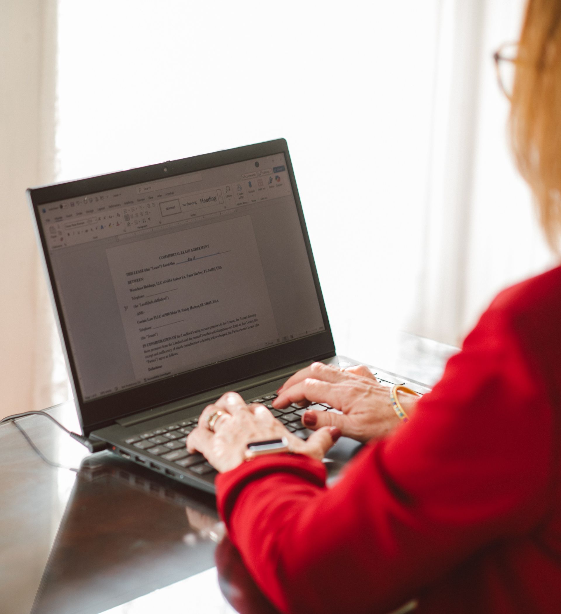 a woman looking at a laptop