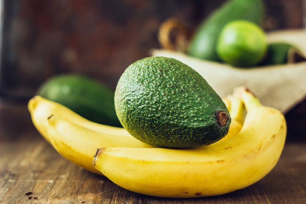 Avocado And-Banana-Over-Brown Wooden Background — Fresh to Door In Queanbeyan NSW