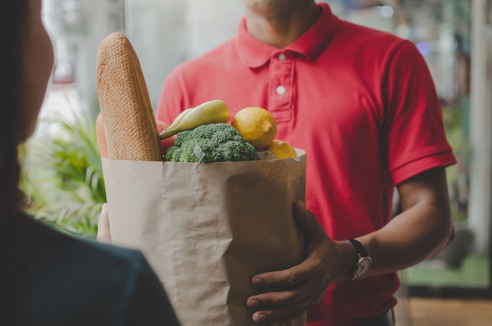 Man In Red Uniform Handing Fresh Vegestables Delivery — Fresh to Door In Fyshwick ACT