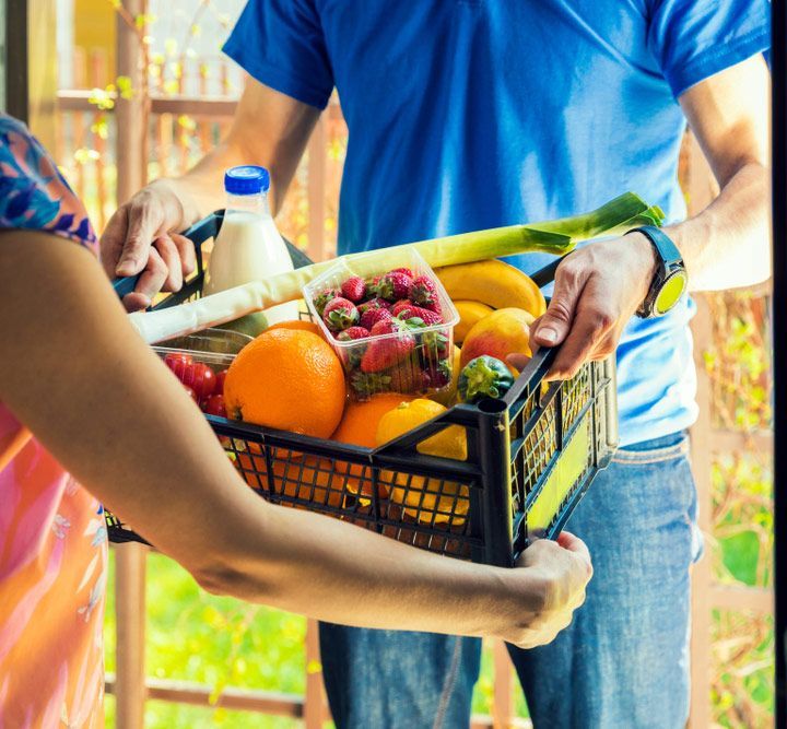Woman Accepting Groceries Box From delivery Man — Fresh to Door In Fyshwick ACT