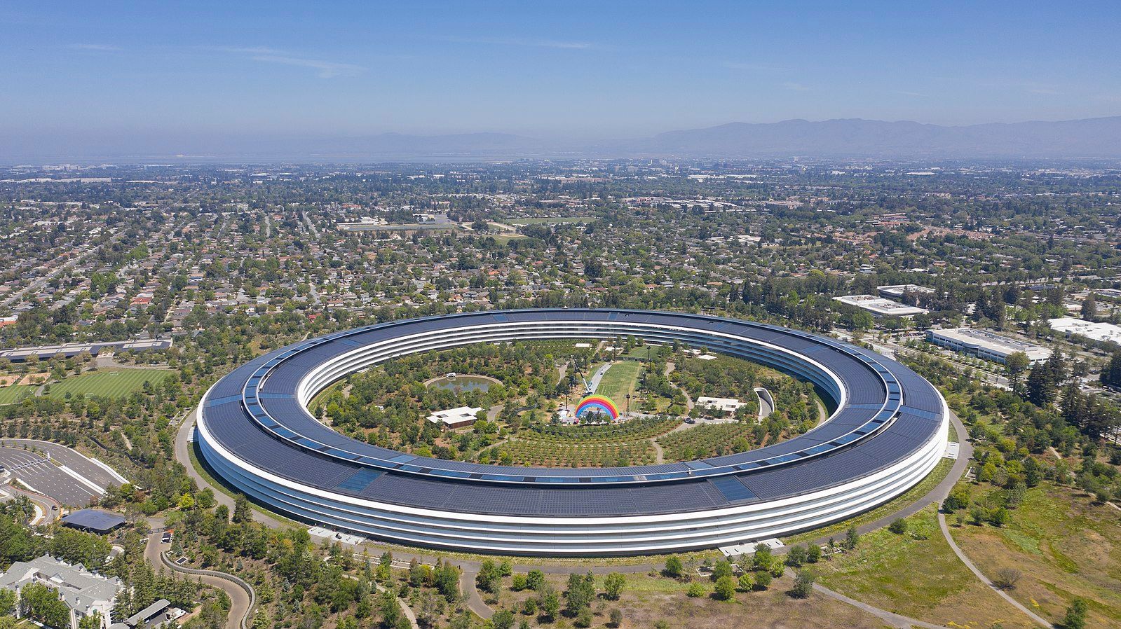 An aerial view of a large building surrounded by trees.