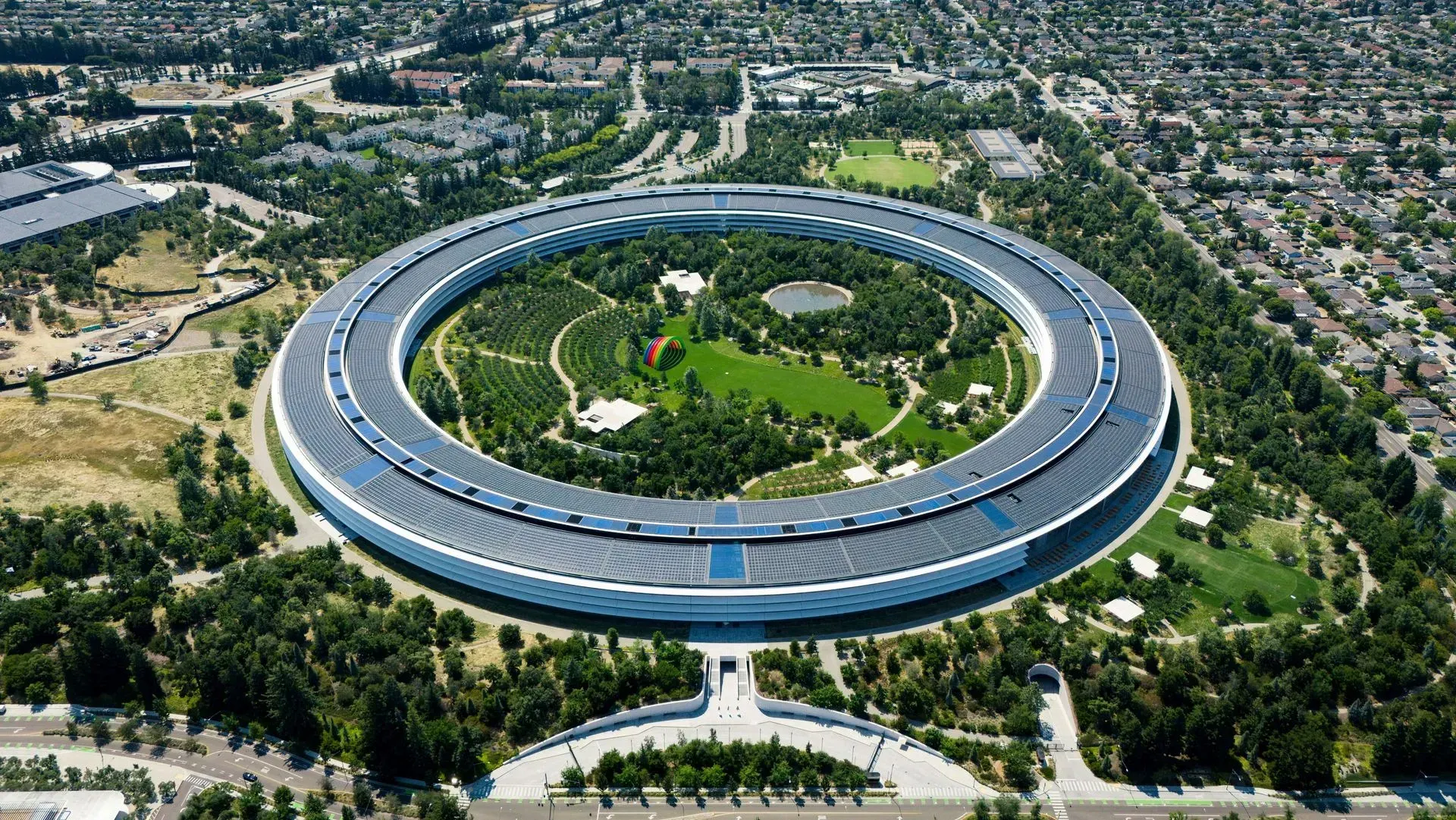 An aerial view of a large building surrounded by trees.