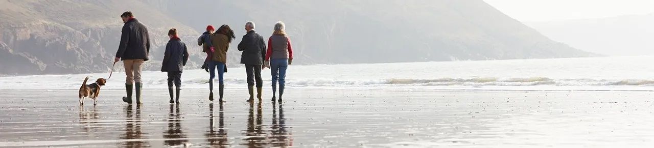 Family enjoying time at the coast knowing they have invested at Precision Capital.