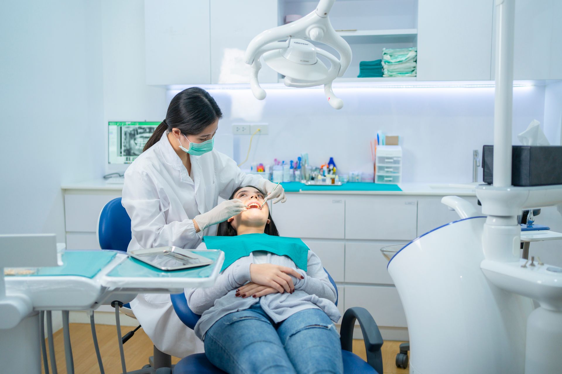 Dentist examining a patient in a bright, modern dental clinic Dentist examining a patient in a bright, modern dental clinic