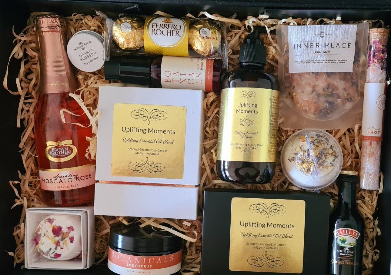 Pamper hamper with assorted candles, jars, and bottles arranged in a decorative gift box