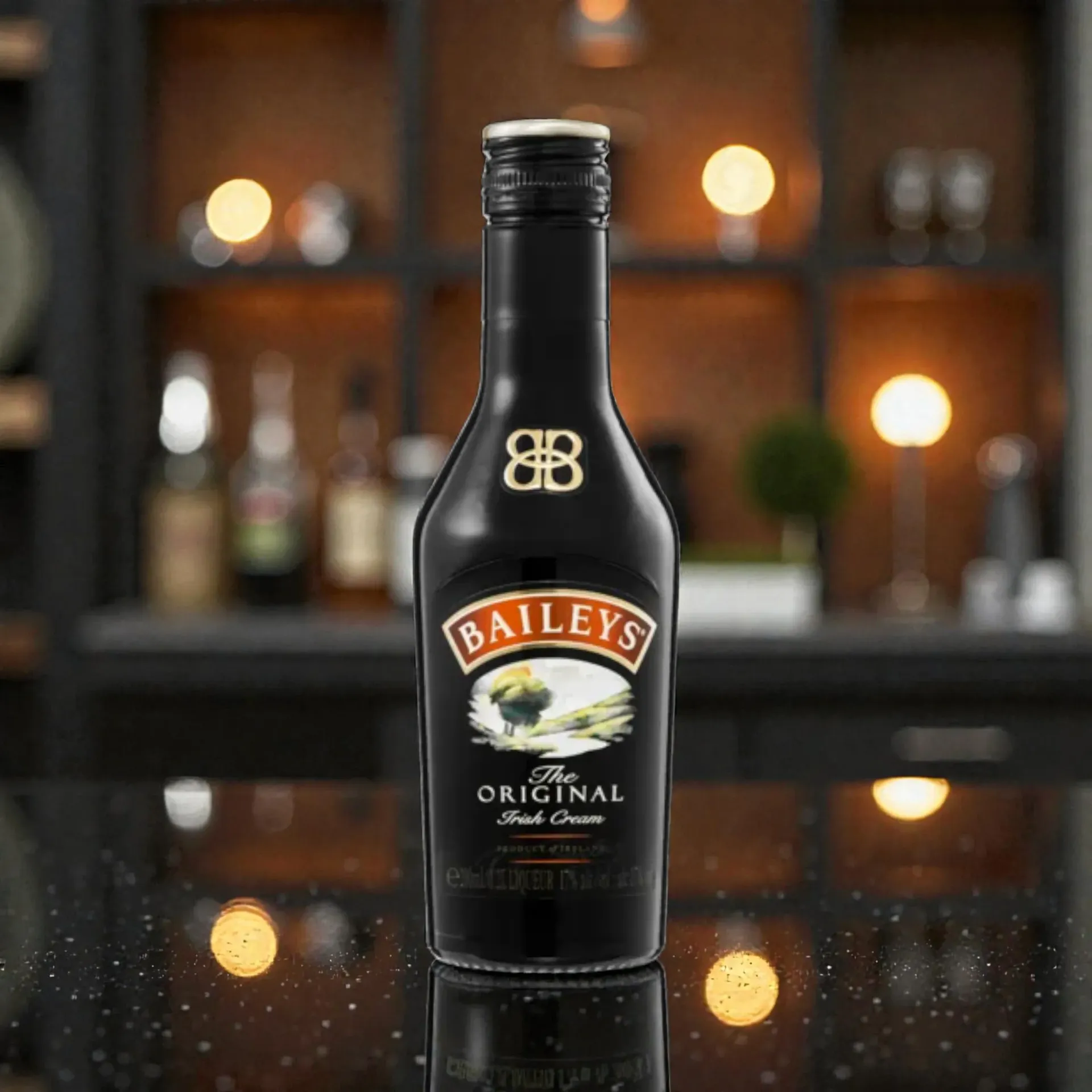 Baileys Original Irish Cream bottle on a bar counter with warm blurred lights in the background