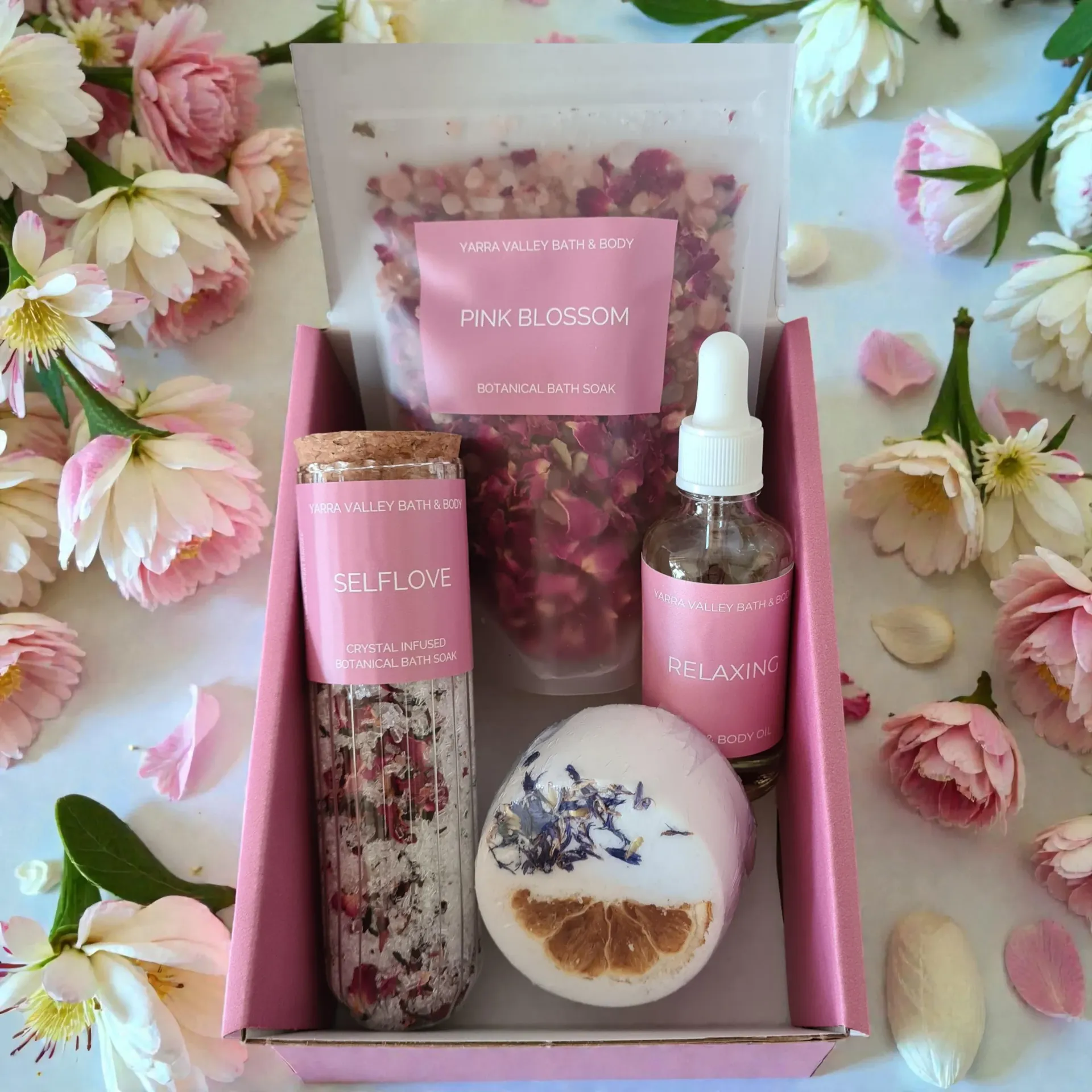 Pink Yara Valley Bath & Body Bath Rituals gift box on a light wooden surface with flowers and leaves