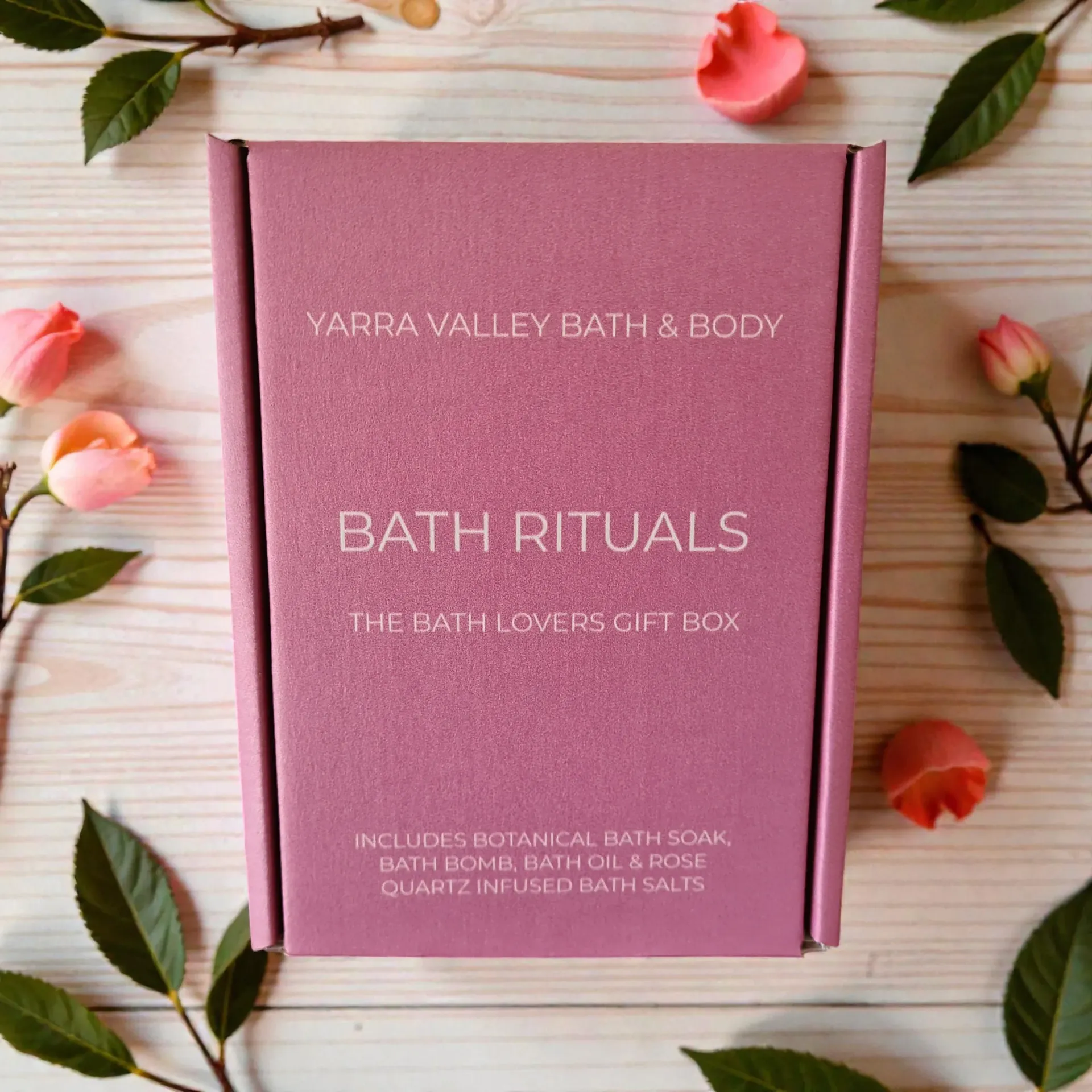 Pink Yara Valley Bath & Body Bath Rituals gift box on a light wooden surface with flowers and leaves