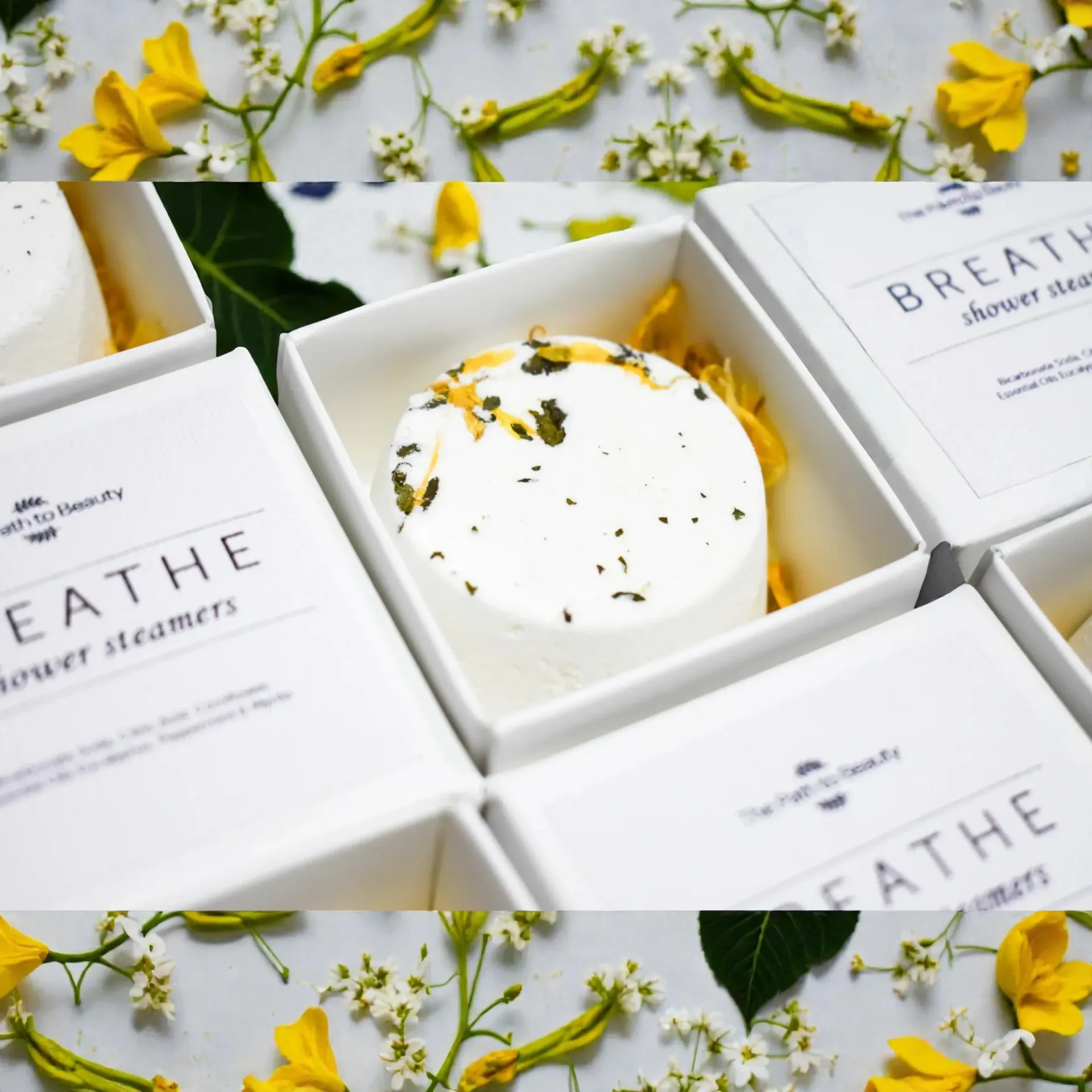White shower steamer in a white gift box with BREATHE labels and yellow flowers around it