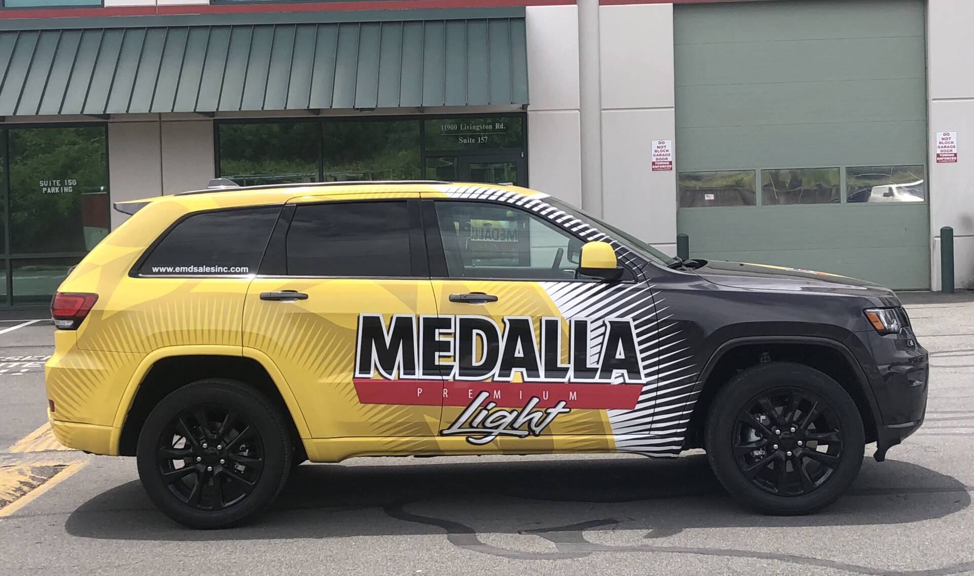 business information on white and yellow SUV