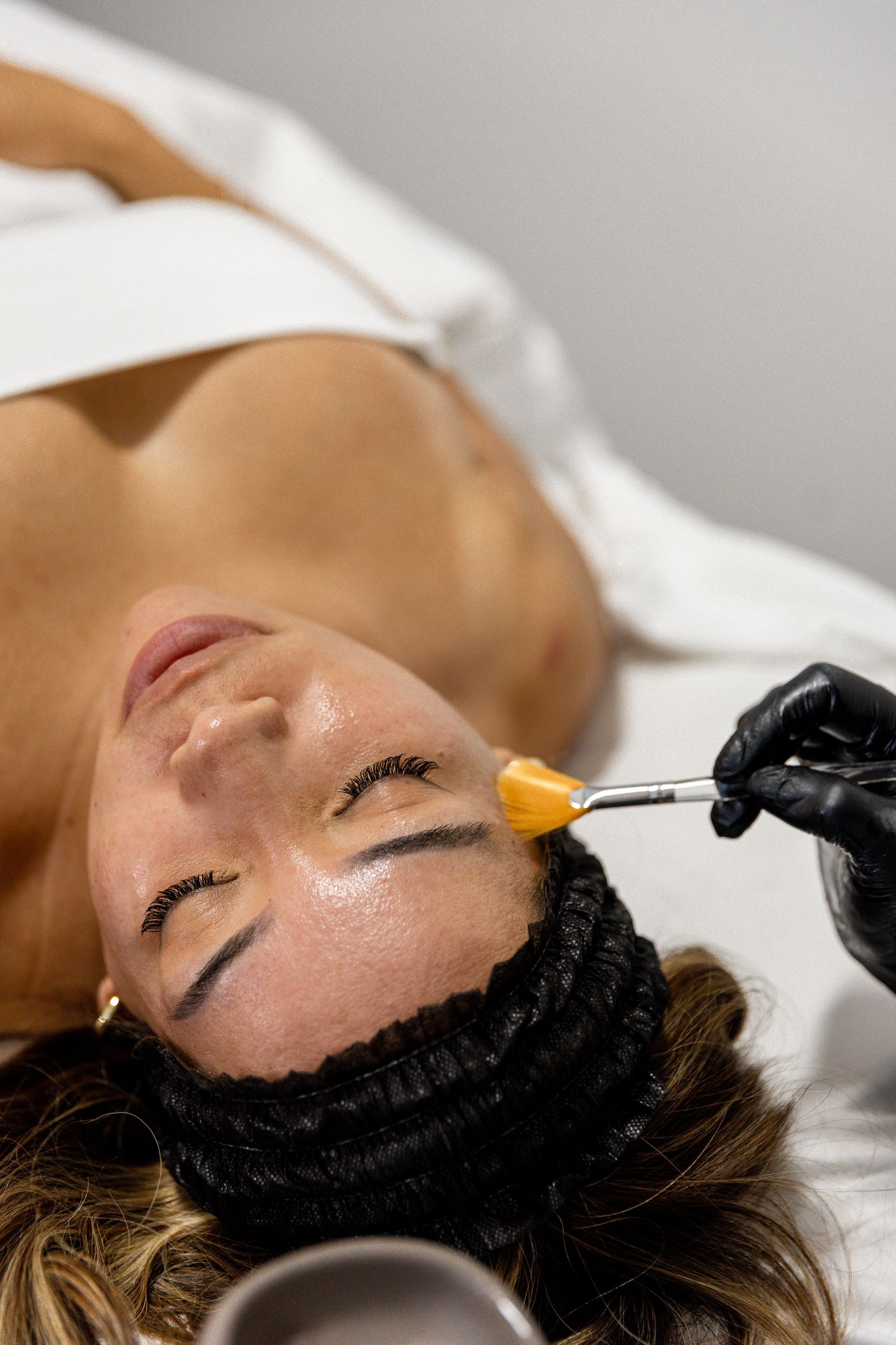Clinician applying treatment to a patient reclined in a dental chair