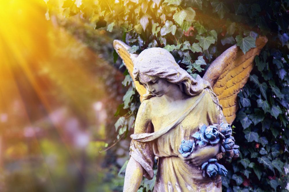Statue Of Golden Angel Illuminated By Sunlight — Funeral Directors in Sydney & Central Coast, NSW