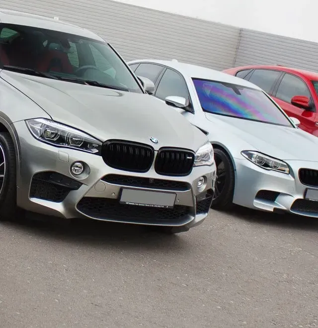Row of vehicles parked outside | Boston Motor Werks