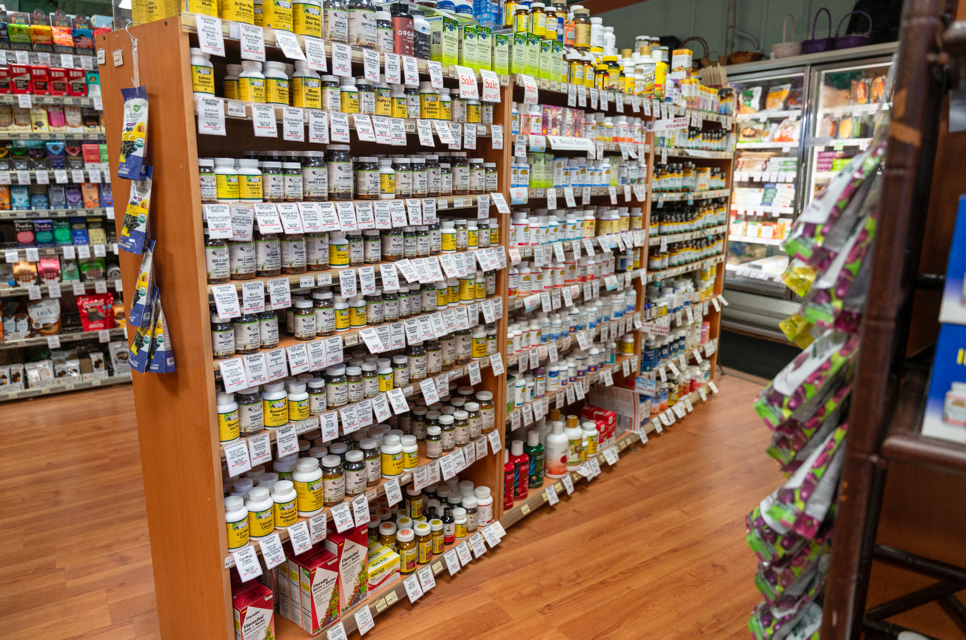 A grocery store aisle filled with lots of products.
