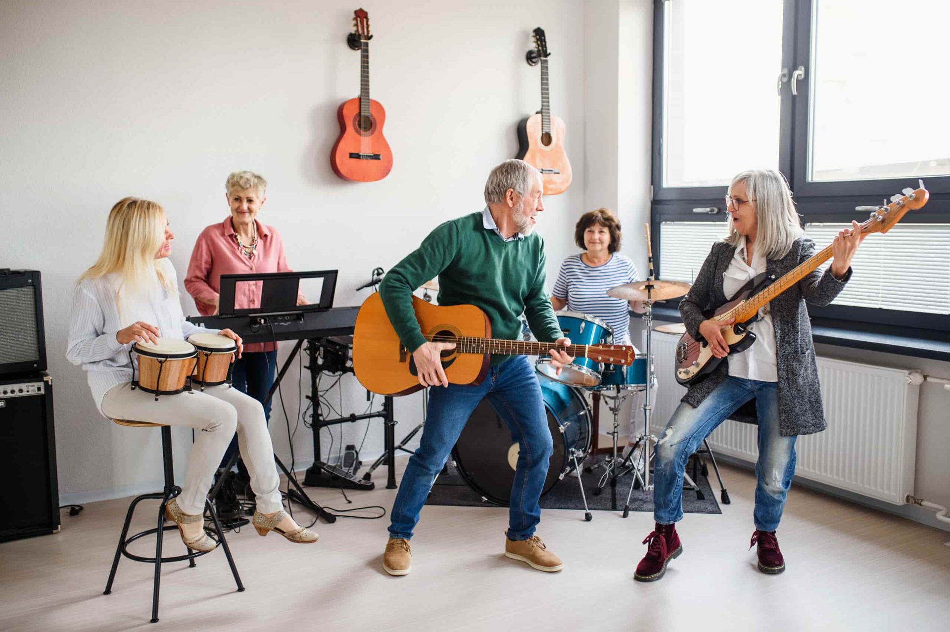 A Group of People Are Playing Musical Instruments in a Room — Empowering You Disability Services In Maryborough, QLD