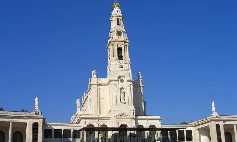 The Basilica of Our Lady of the Rosary at the Sanctuary of Fátima under a blue sky