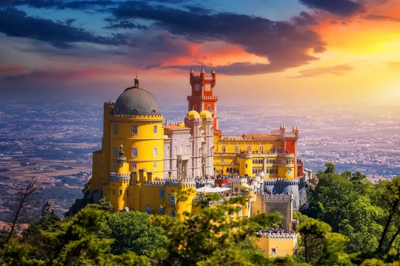 Pena Palace on its hilltop in the Serra de Sintra at sunset