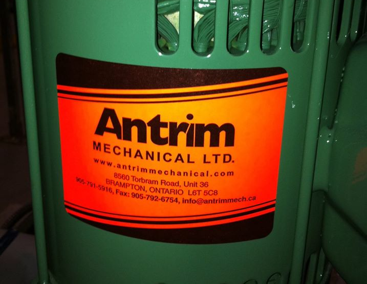 A green container with an orange label that says ' antrim mechanical ltd '