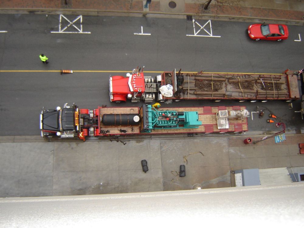 An aerial view of two trucks on a city street