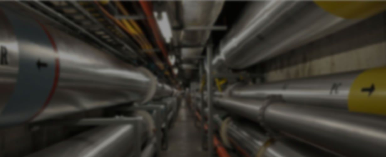 A blurred image of a tunnel filled with pipes and tubes.
