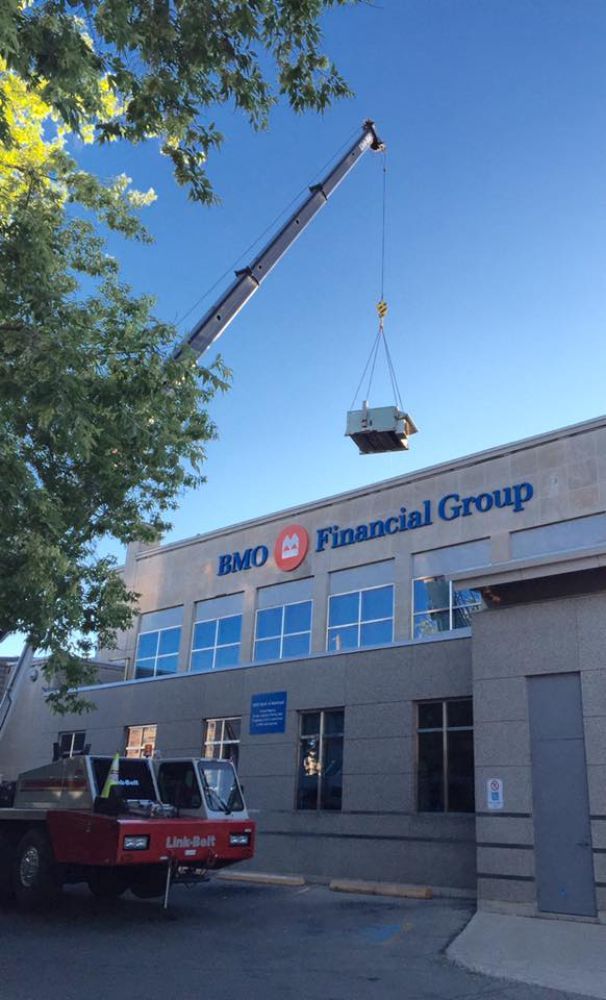 A red truck is parked in front of an amd financial group building