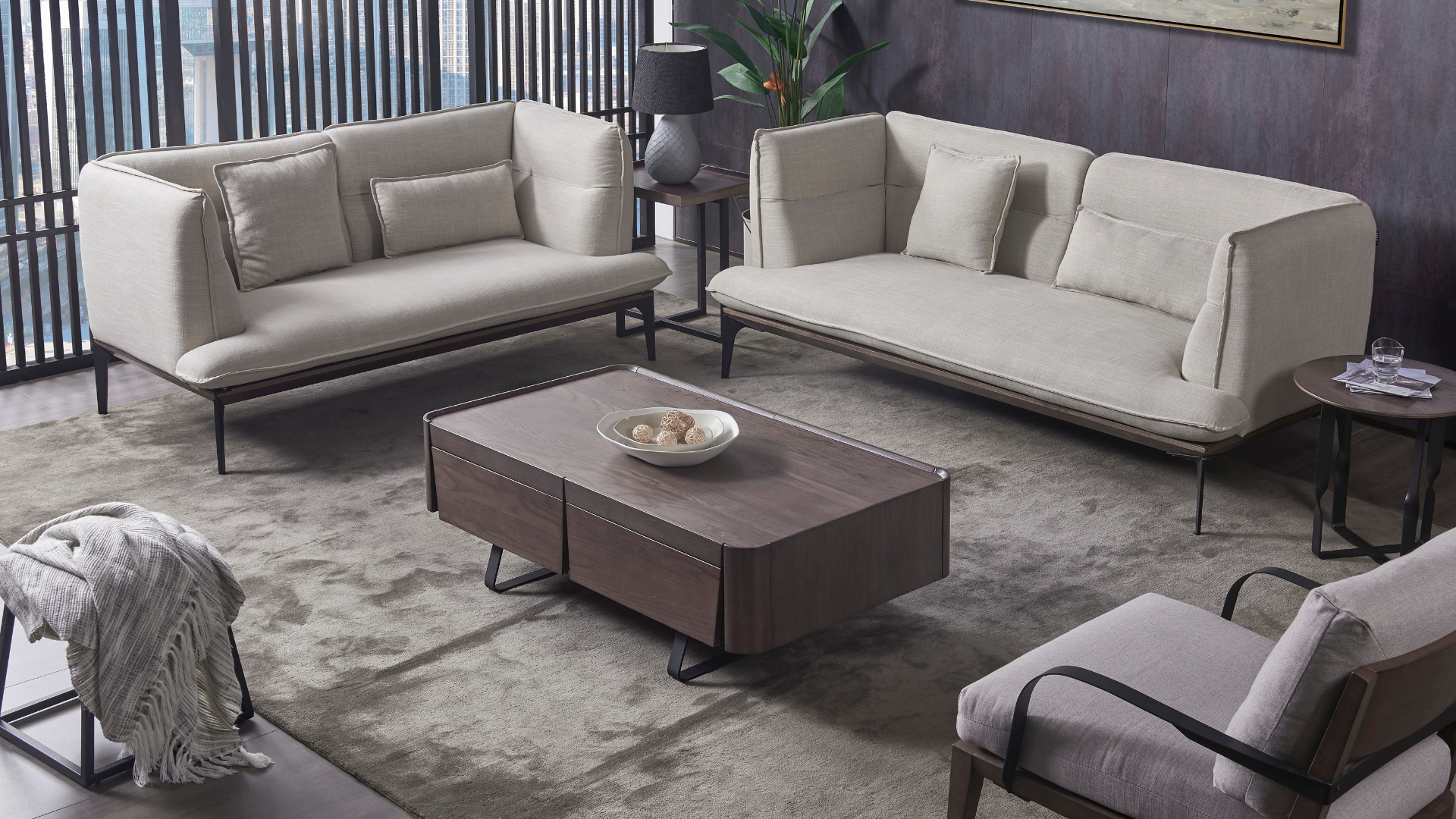 Living room furniture set: two sofas, a chair, a coffee table, and a side table. Beige seating, brown table, gray rug.