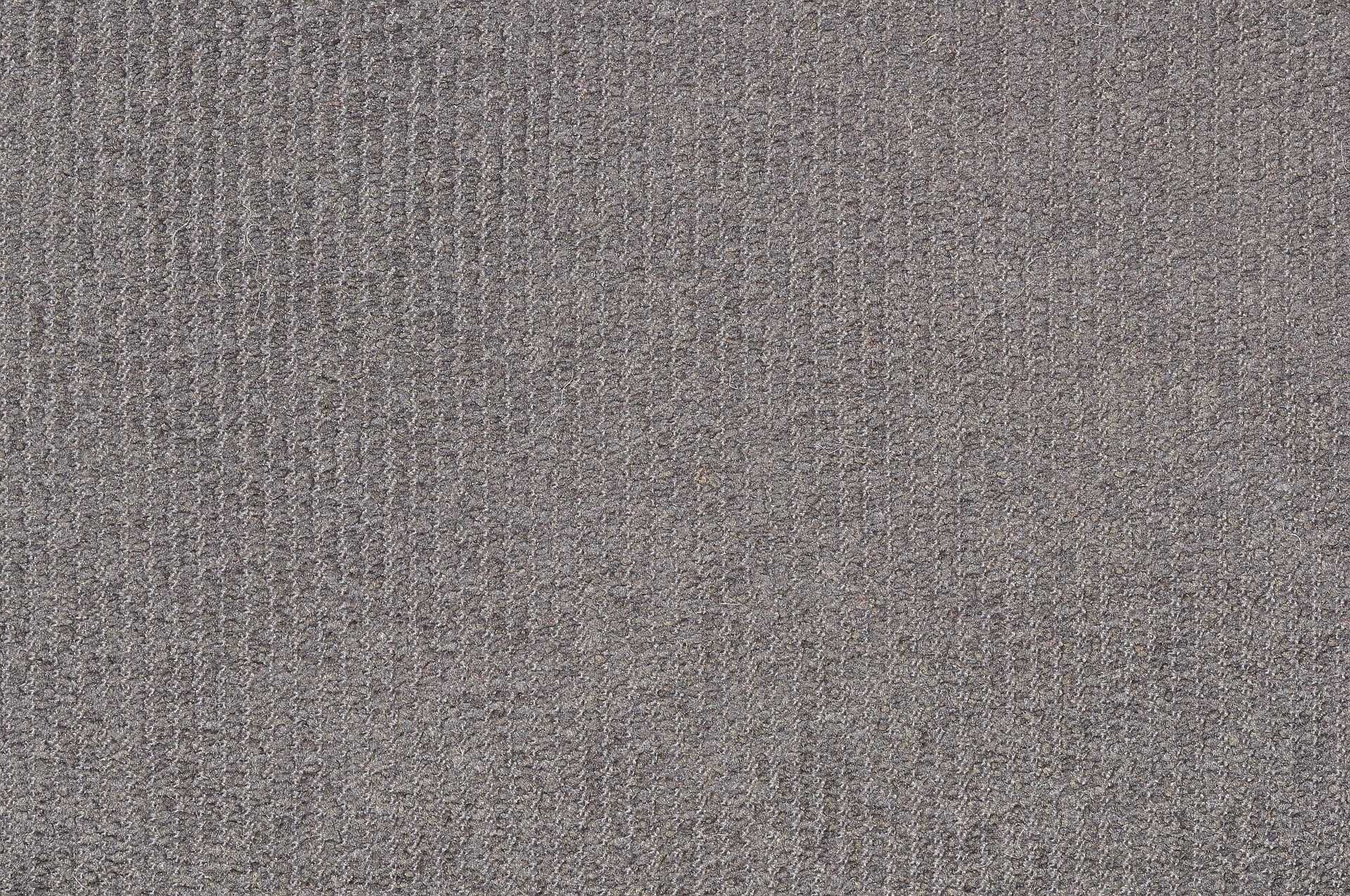 Close-up view of a textured, woven fabric in a muted gray color.