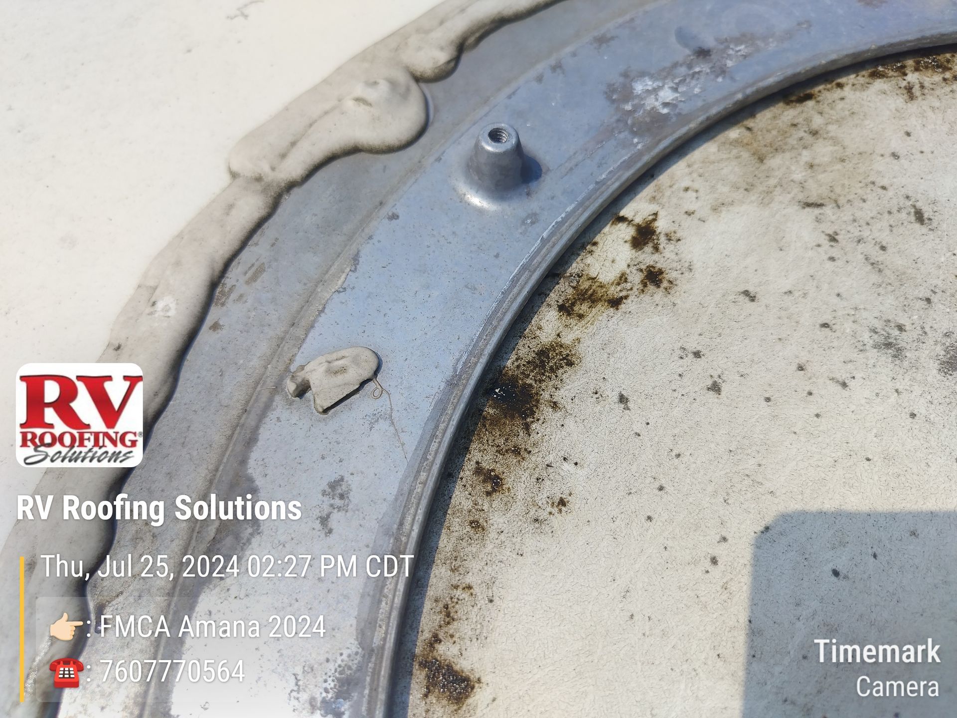 Close-up of an RV roof vent with sealant. The vent is round, and a logo for RV roofing solutions is in the corner.