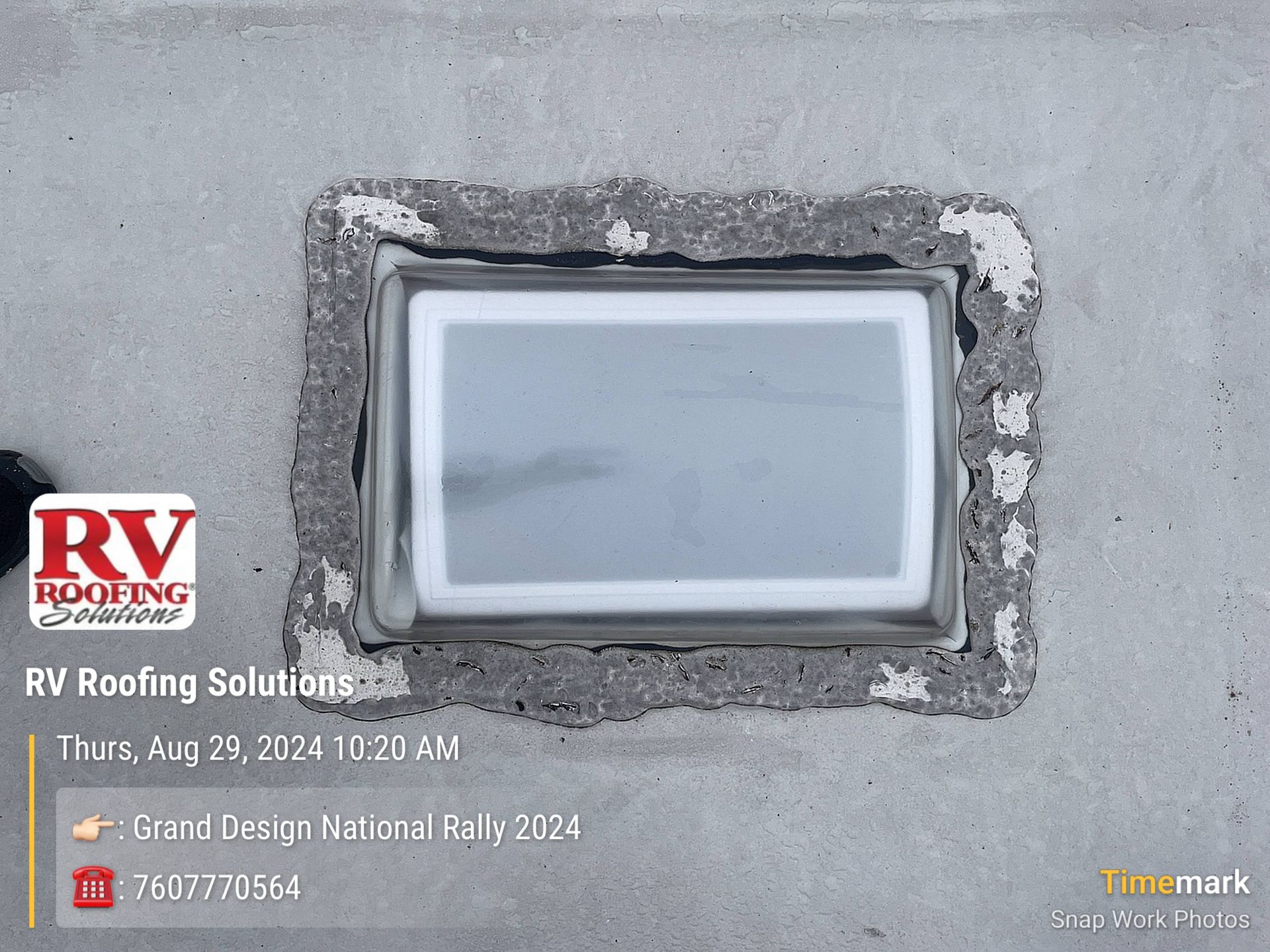 A rectangular glass block installed in a concrete wall, likely for RV roofing.