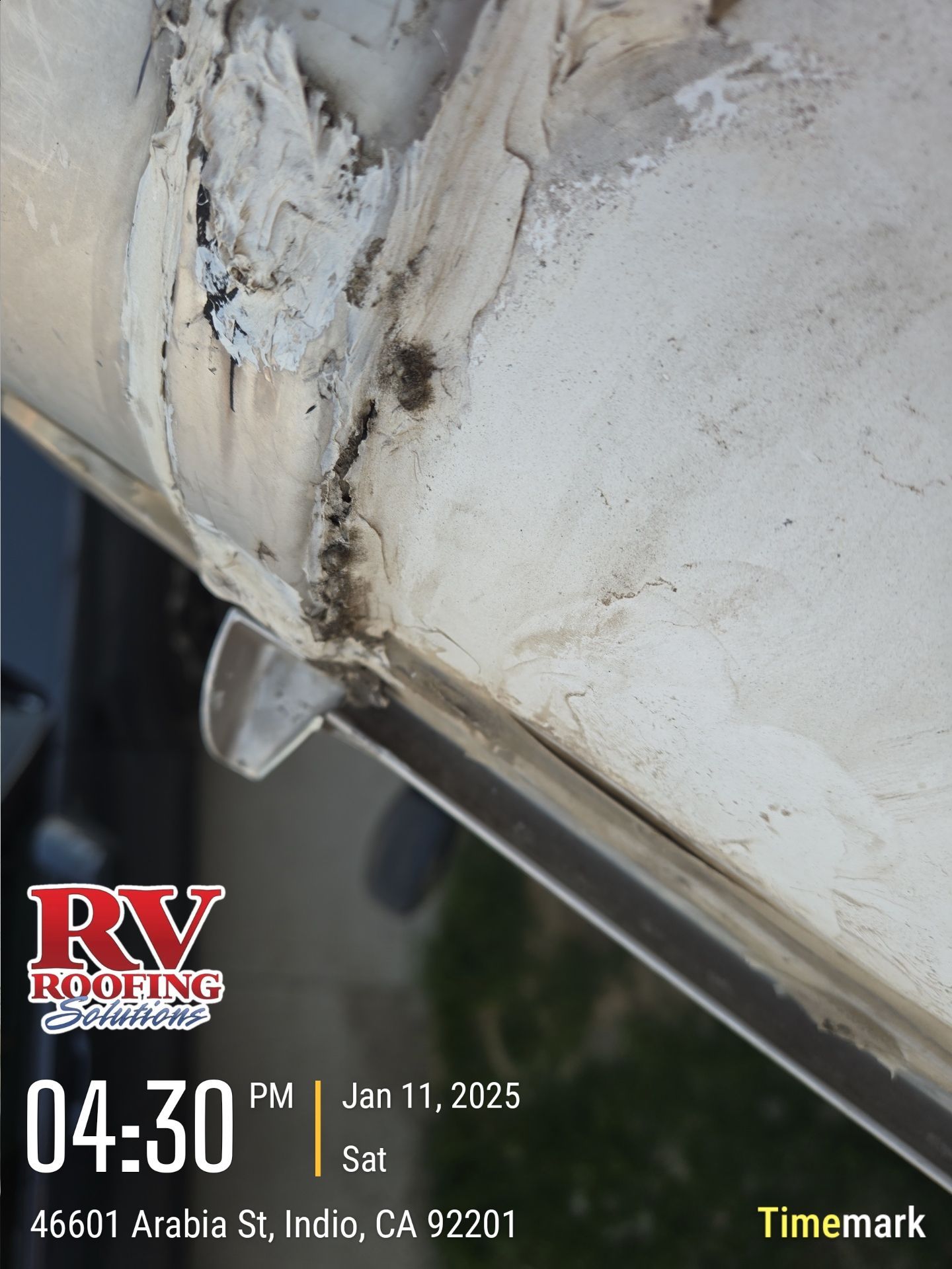 Close-up of damaged RV roof edge with sealant breakdown; likely needing repair. Dated Jan 11, 2025.