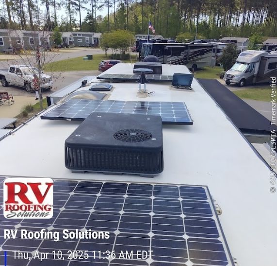RV roof with solar panels, air conditioner, and RV park in background. The logo
