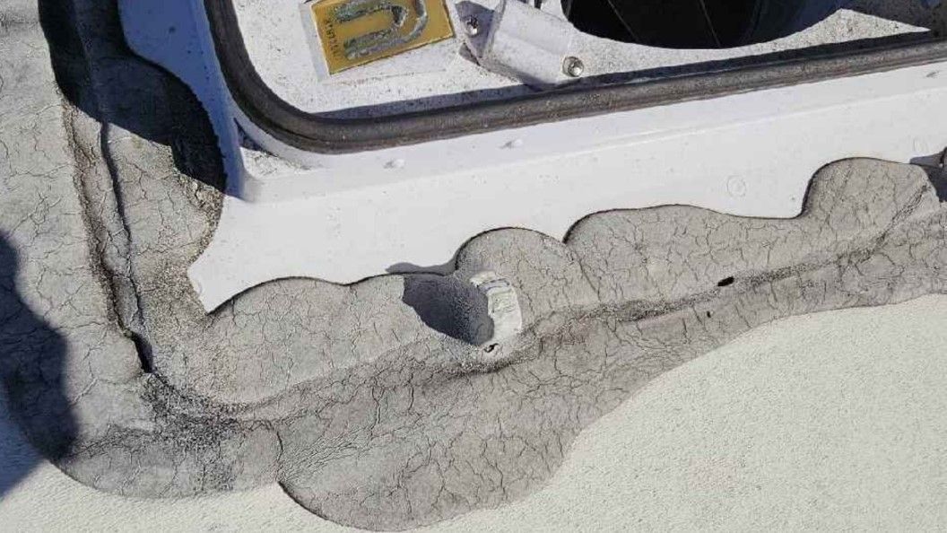 A close up of the mess caulking can be on an RV Roof.