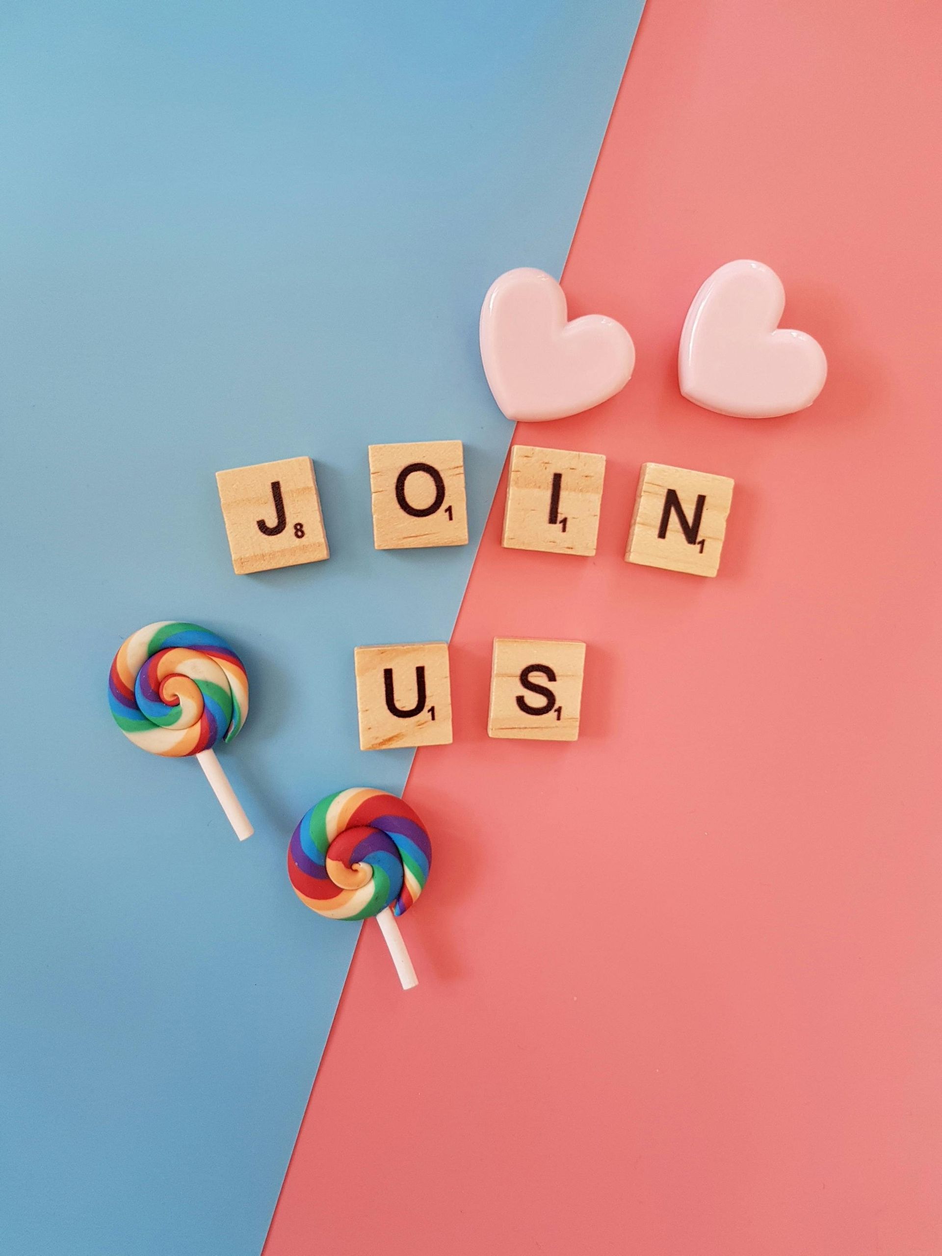 The words join us are written in scrabble tiles on a pink and blue background.