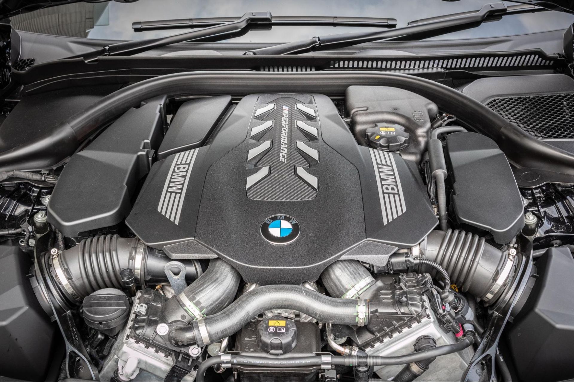 The engine of a bmw is shown with the hood open.