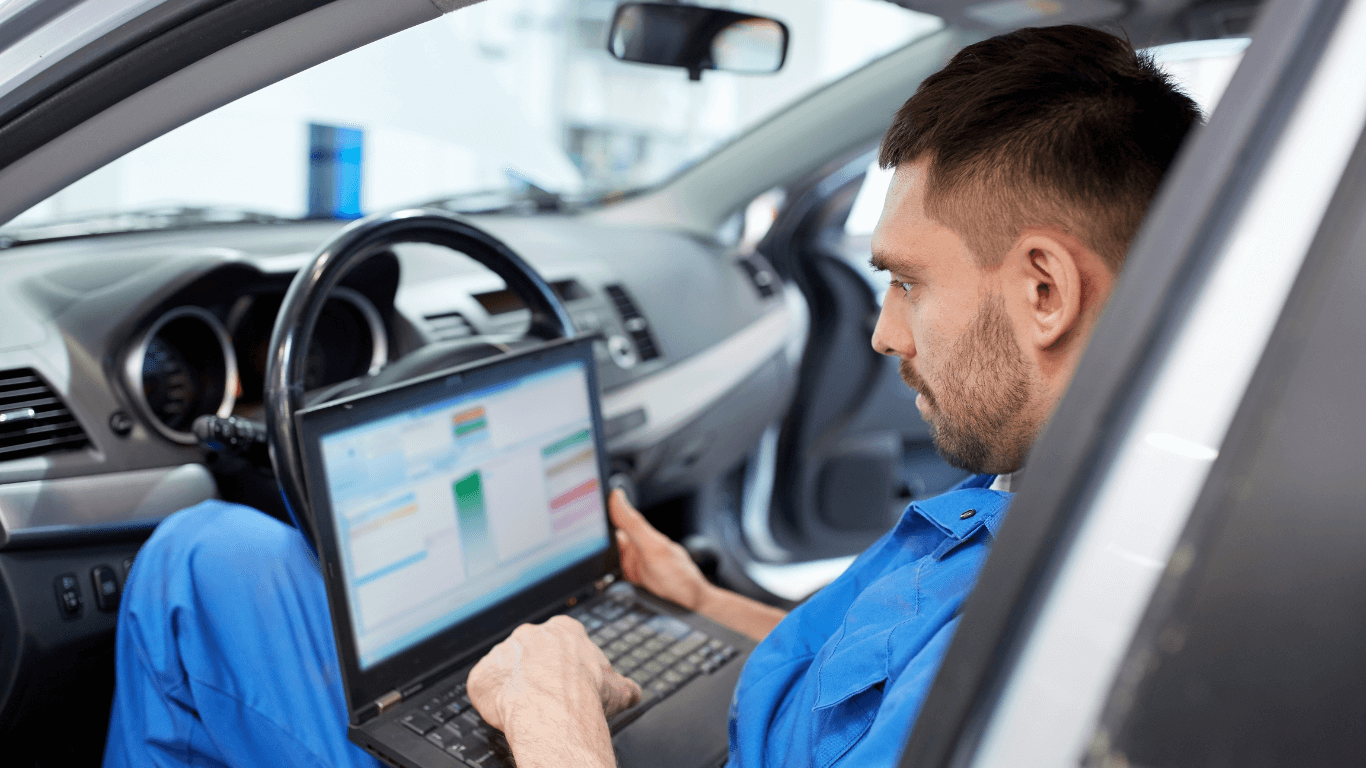 A mechanic doing a car diagnostic in Gainesville GA