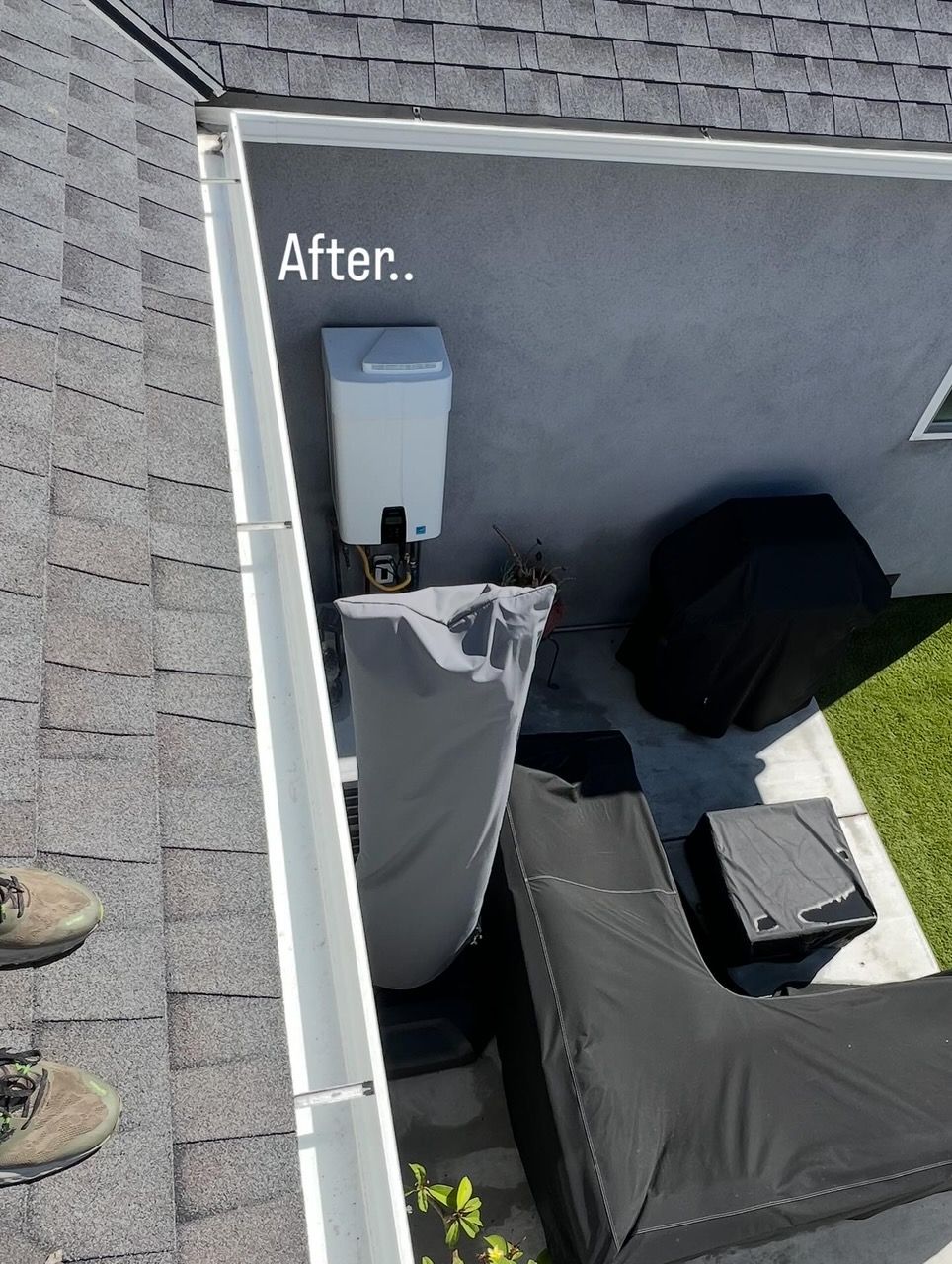 Labeled rooftop corner with gray HVAC units and black covers beside a white wall.