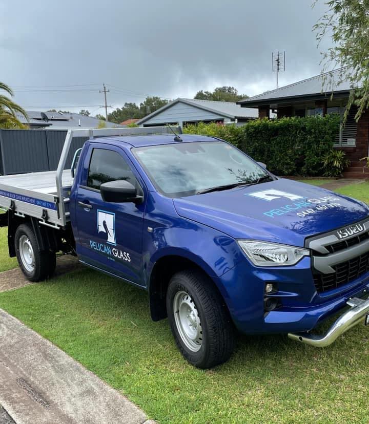 Blue Pelican Truck Parked On Grass — Pelican Glass in Pelican, NSW