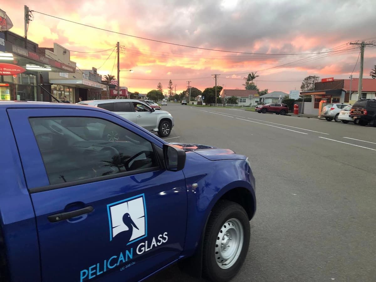 A Blue Pelican Glass Car On The Street — Pelican Glass in Pelican, NSW