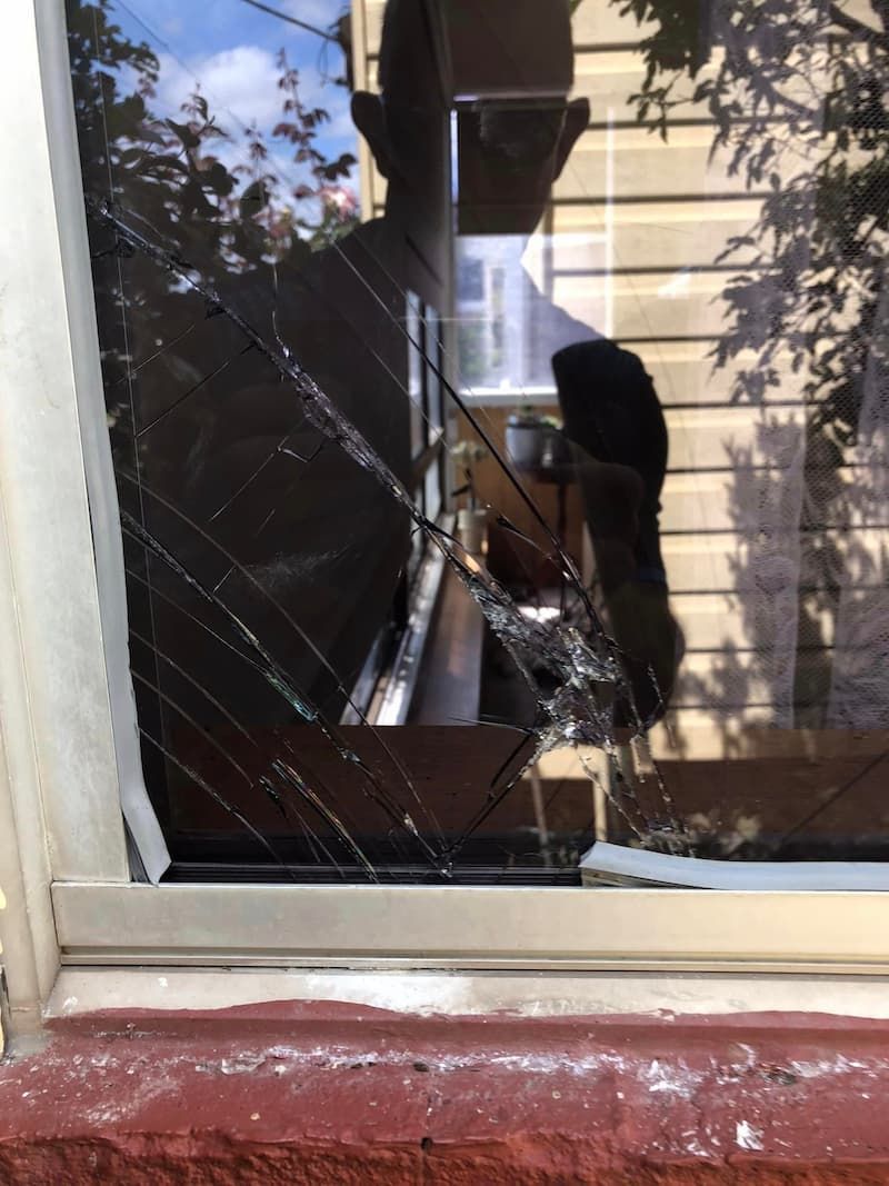 Broken Window With A Person Standing Behind It — Pelican Glass in Pelican, NSW