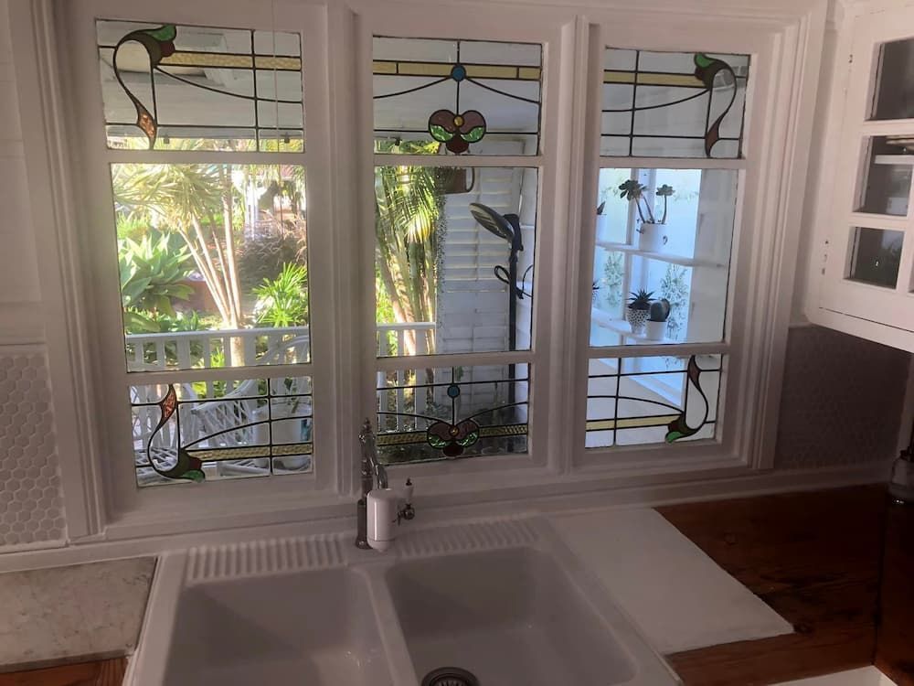 A Kitchen With Two Sinks and Stained Glass Windows — Pelican Glass in Belmont, NSW