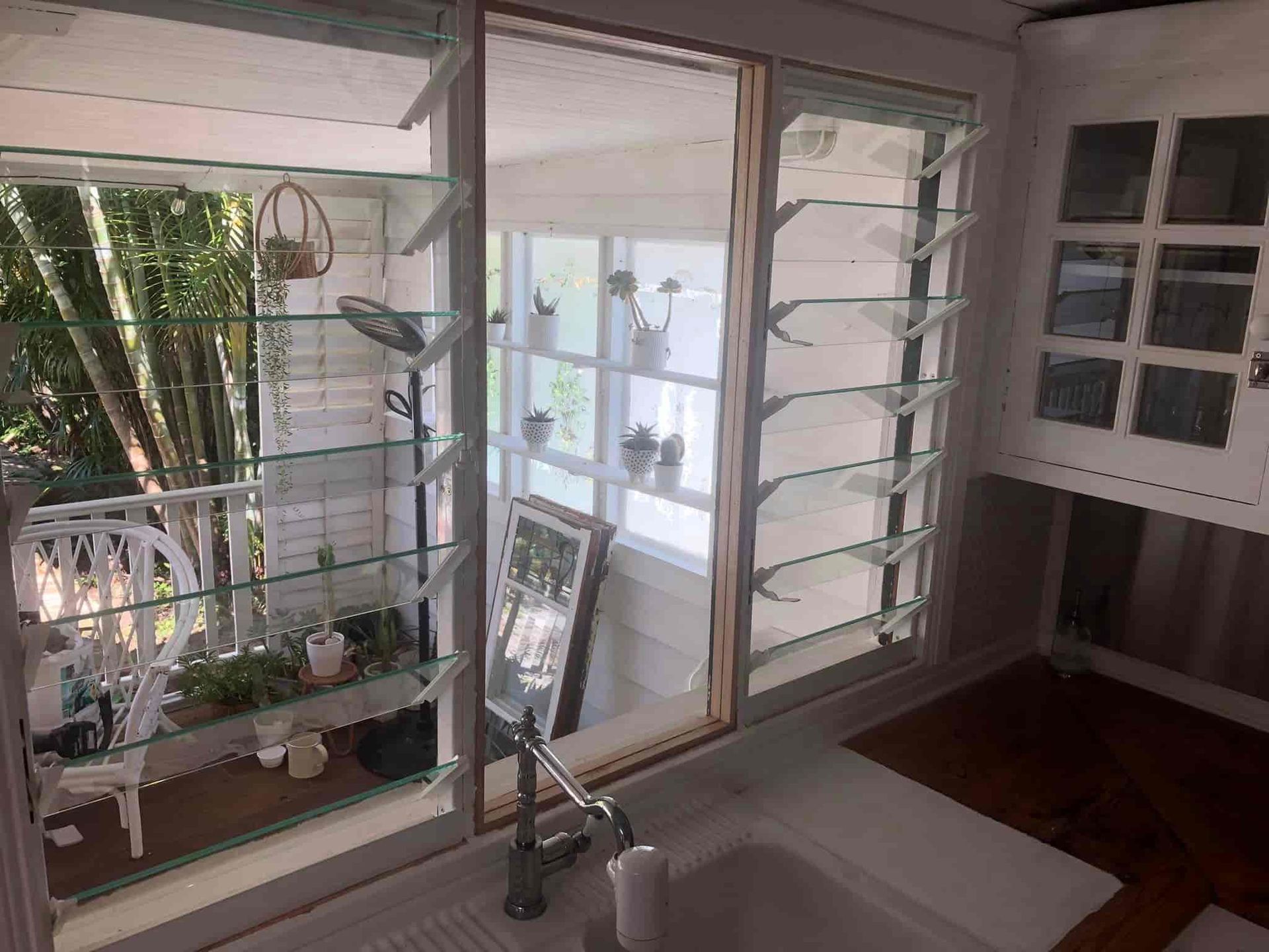A Kitchen With a Sink, Mirror, Shelves and a Window — Pelican Glass in Lake Macquarie, NSW