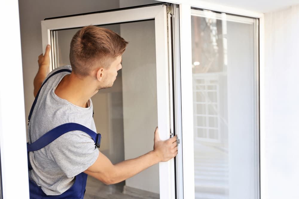 Man Opening A Window — Pelican Glass in Swansea, NSW